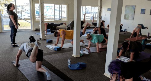 RiversZen students in a streamed studio class adapting the same floor movement to their own bodies